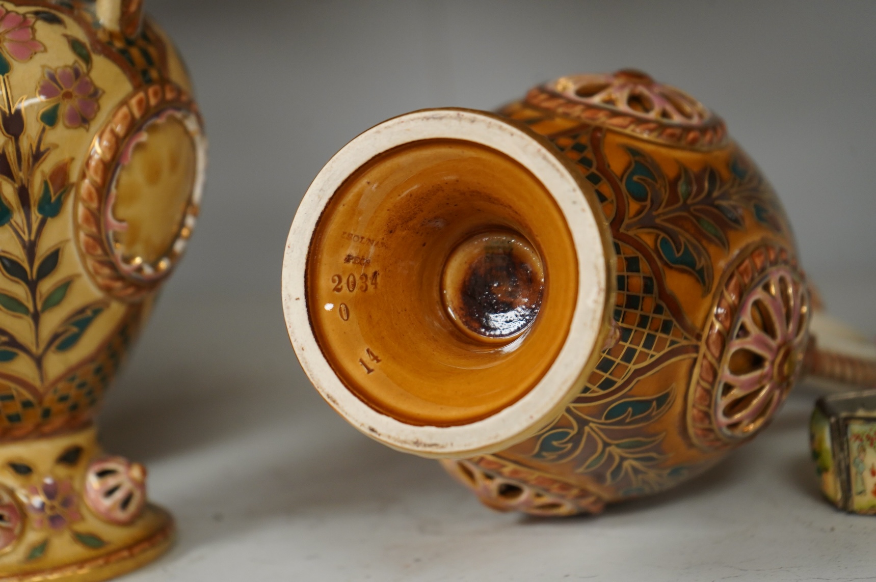 Two Zsolnay Persian inspired jugs / ewers and covers, stamped to the bases 29cm high